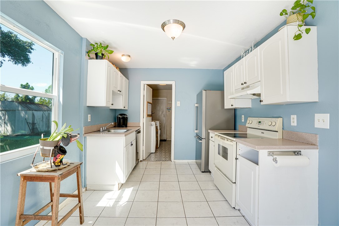 a kitchen with a stove a sink and a refrigerator