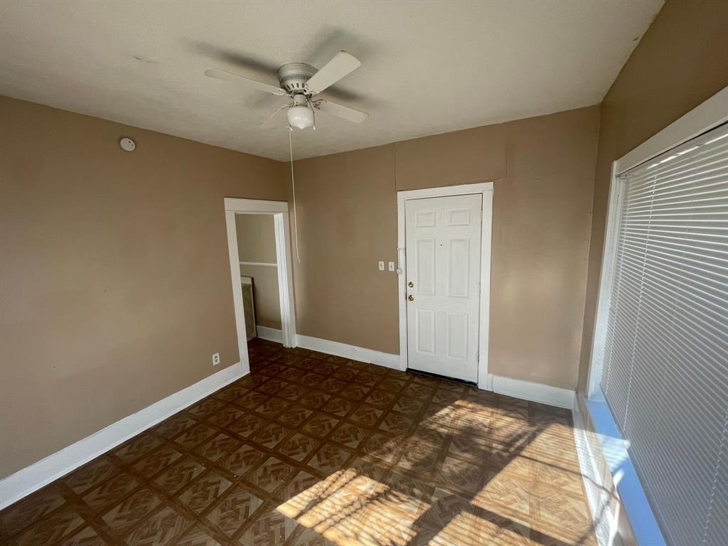 a view of a livingroom with wooden floor and a ceiling fan