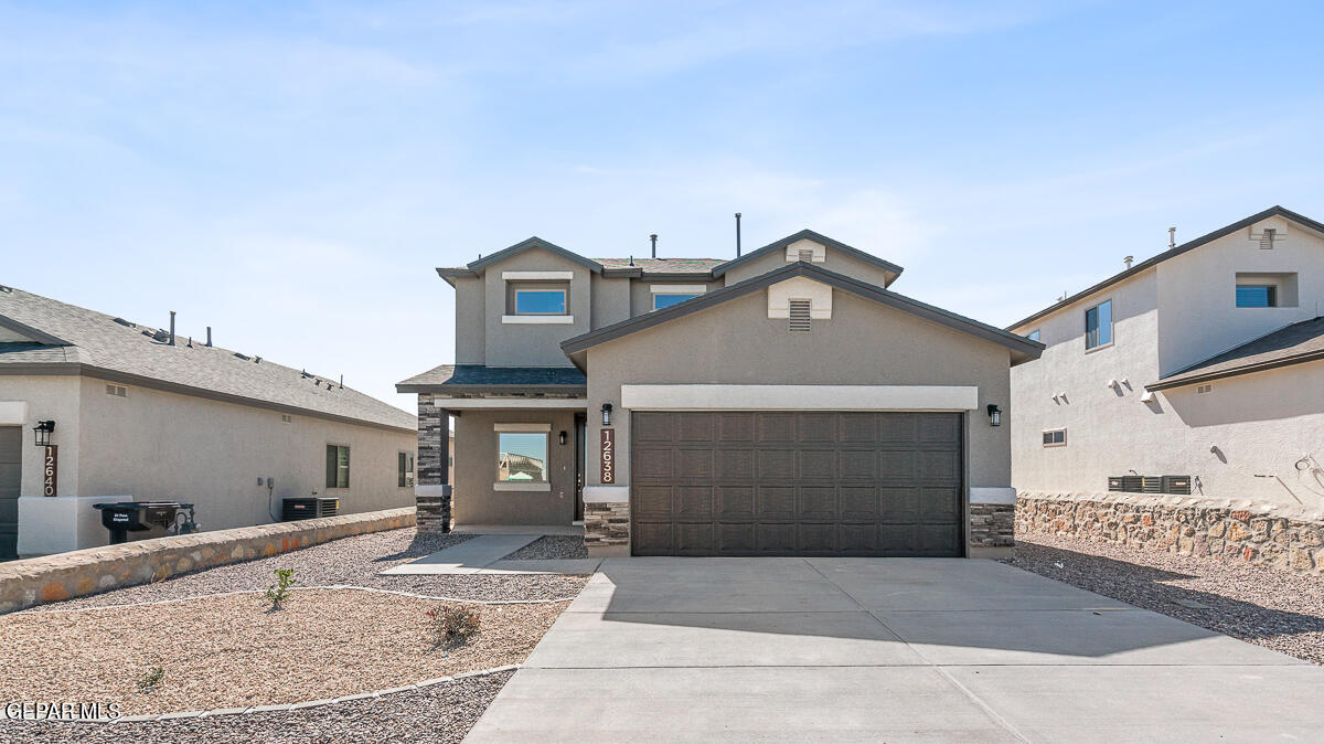 a front view of a house with a yard and garage