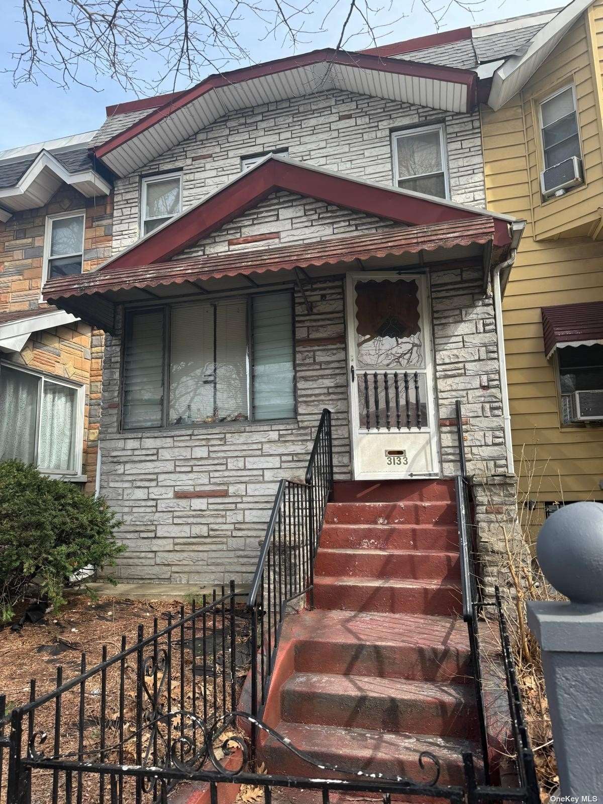 a front view of a house with stairs