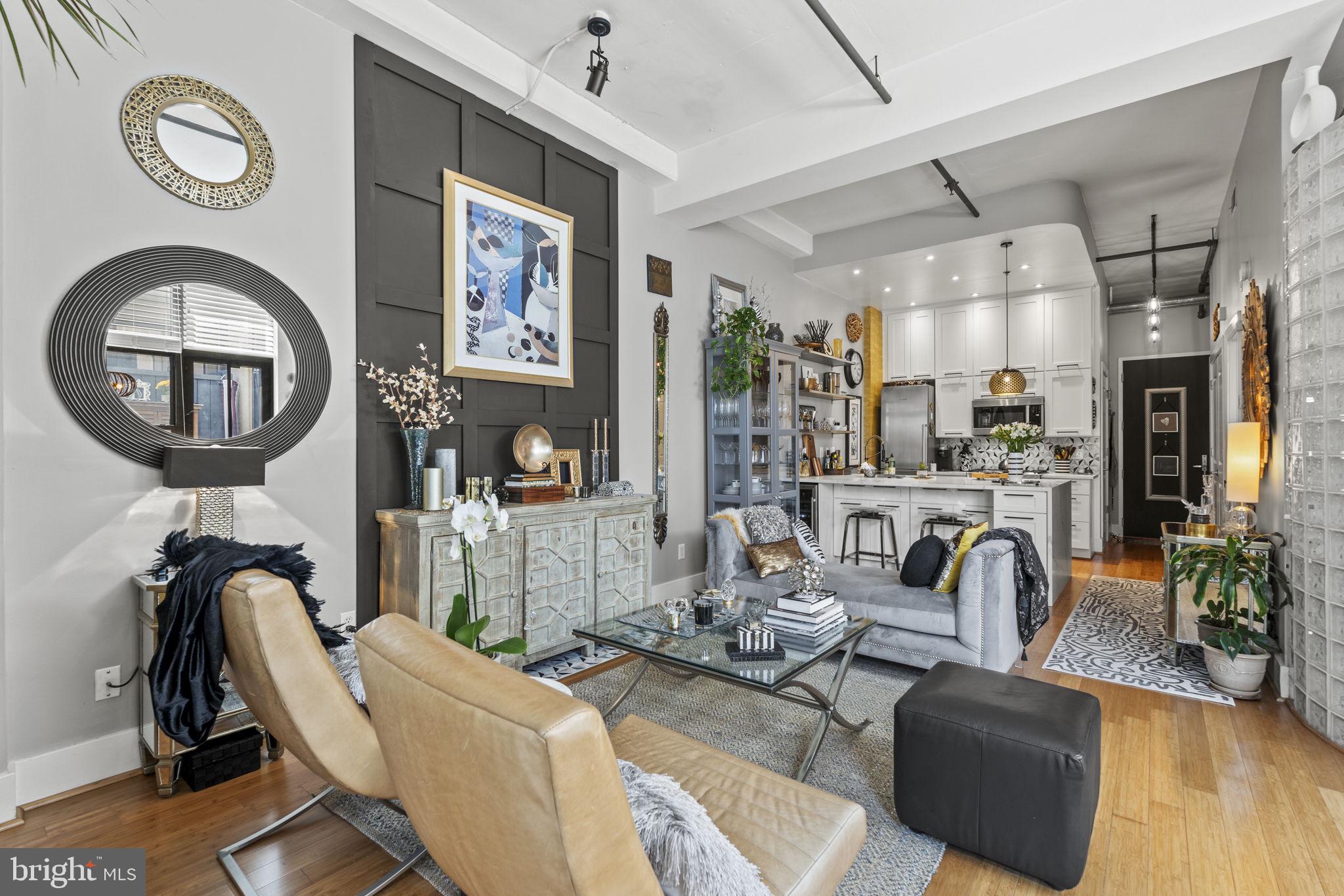 a living room with furniture a flat screen tv and a large window