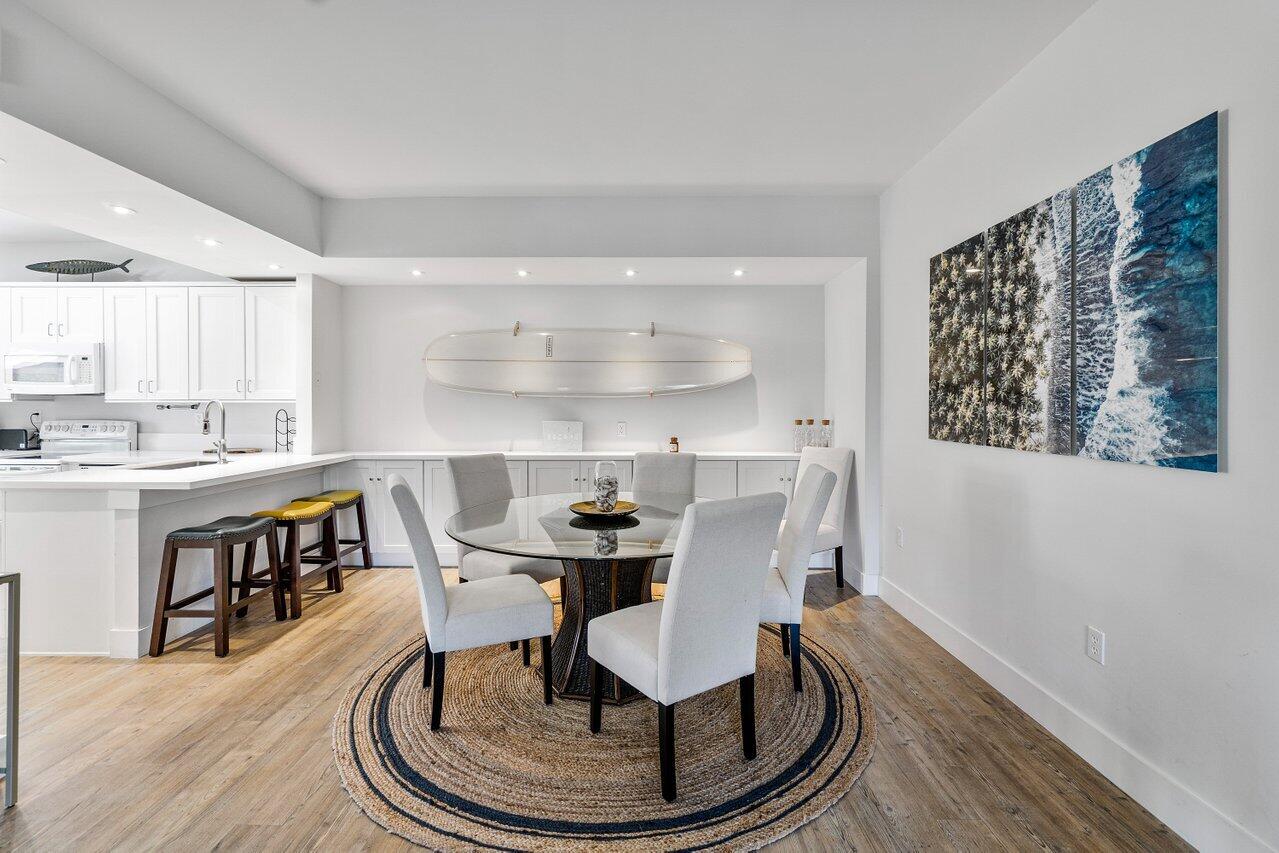 a dining room with furniture a rug and wooden floor