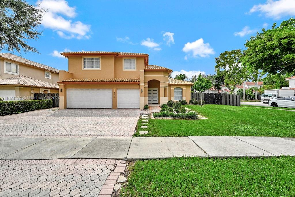 a front view of a house with a yard and garage