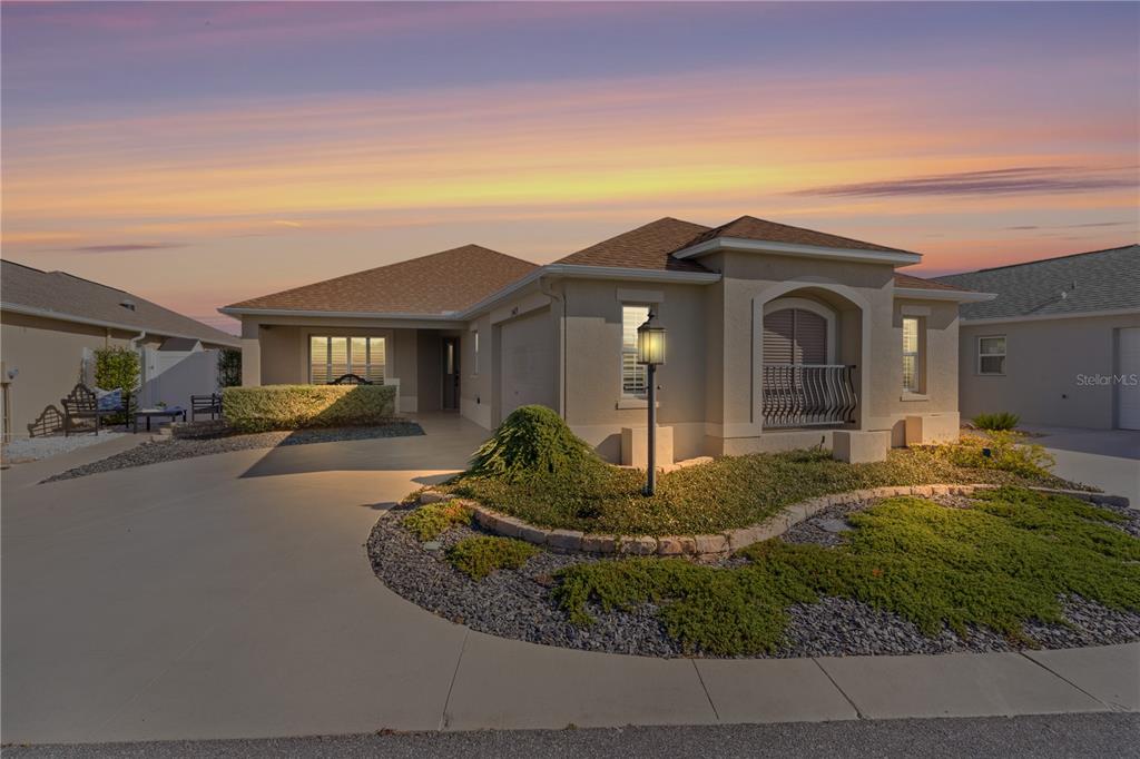 a front view of a house with garden