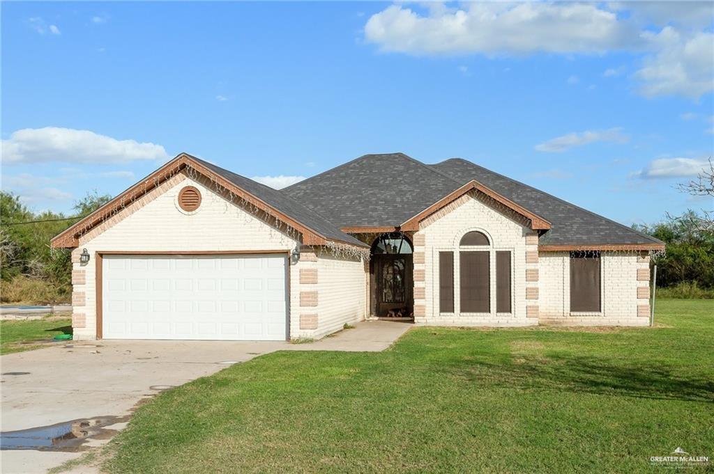 a view of front of house with a yard