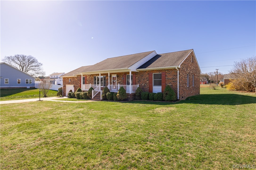 a front view of a house with a yard and swimming pool