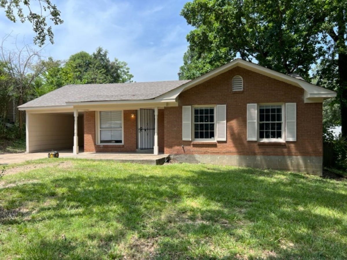 a house that has a big yard with large trees