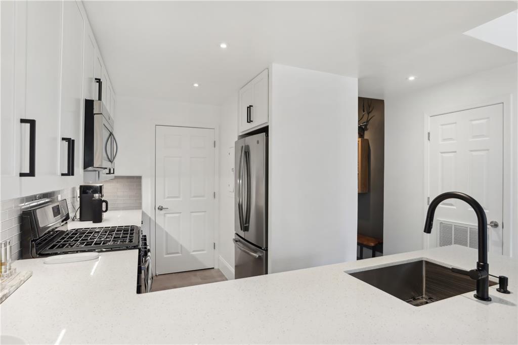 a kitchen with a refrigerator and a sink