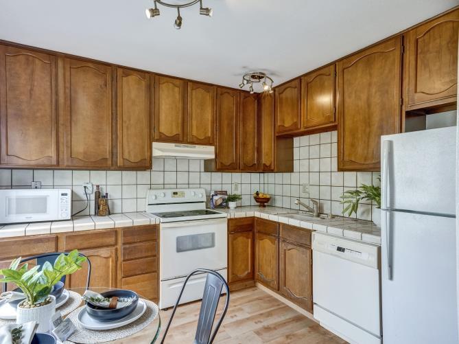 a kitchen with a sink stove and refrigerator