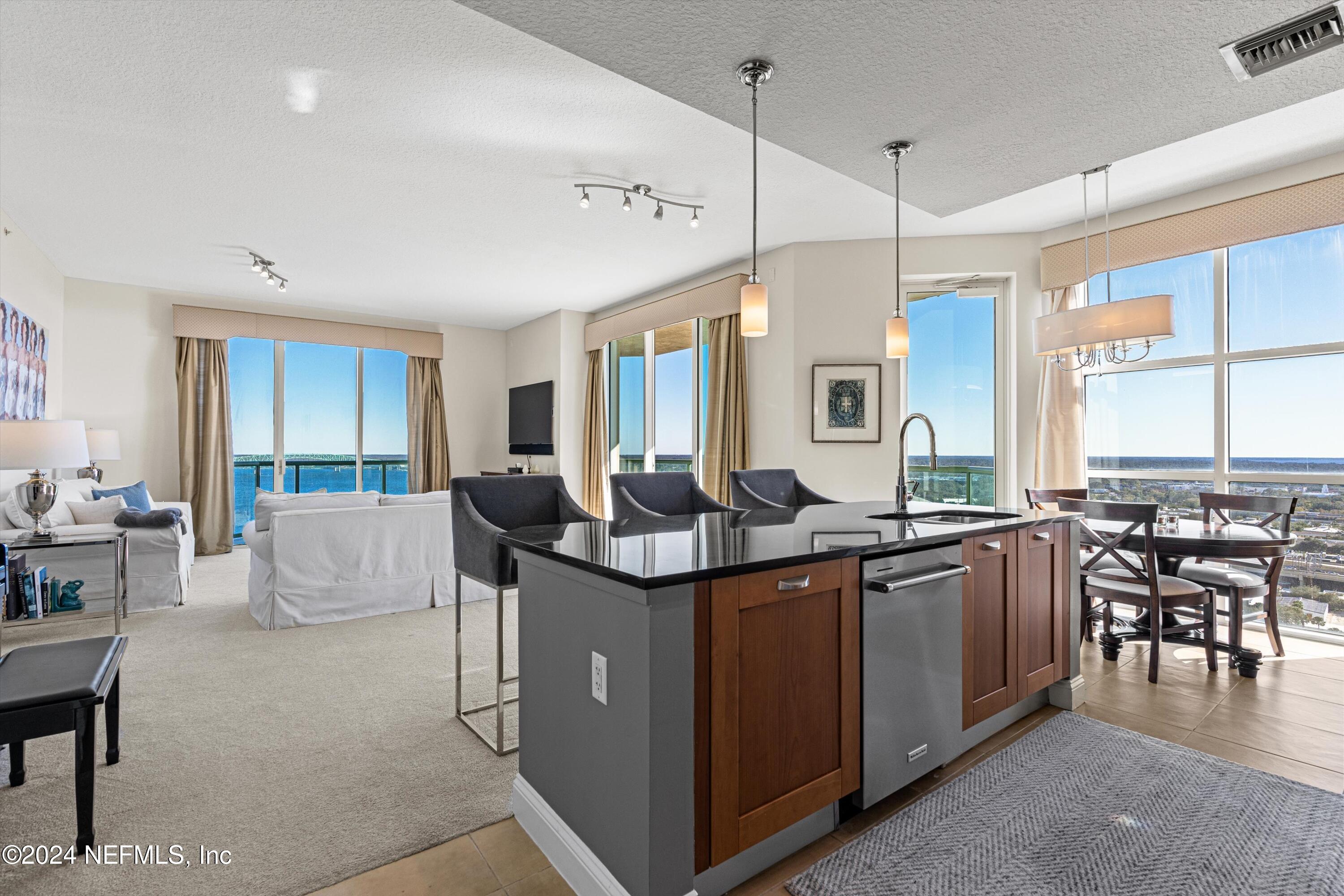 a open kitchen with stainless steel appliances granite countertop a stove and a refrigerator