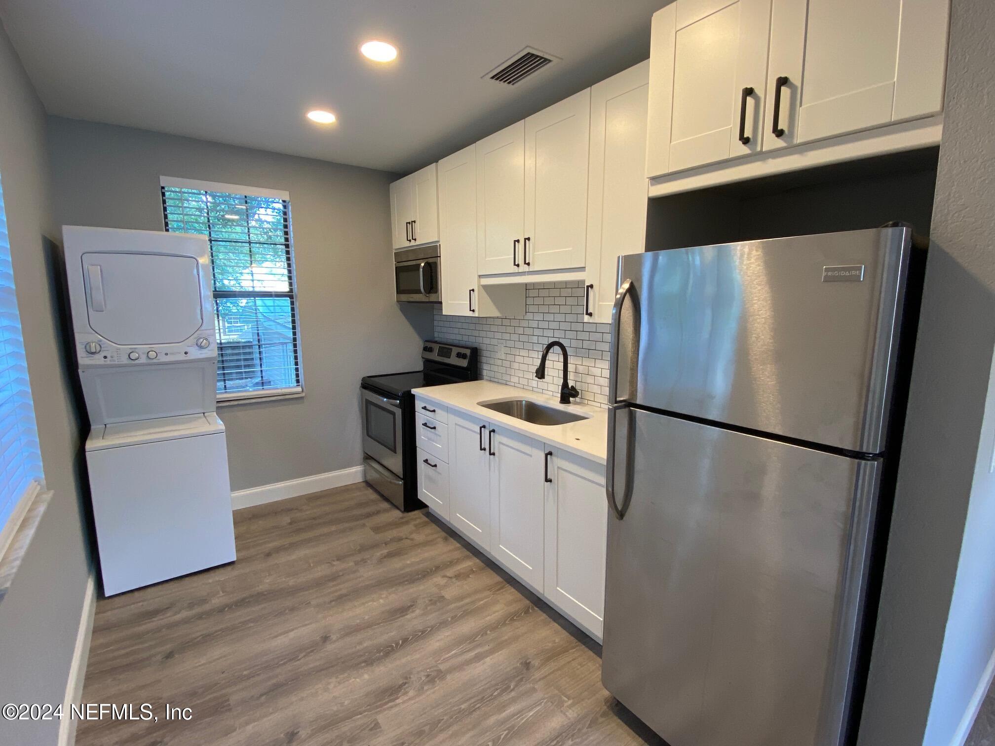 a kitchen with a refrigerator a sink and dishwasher