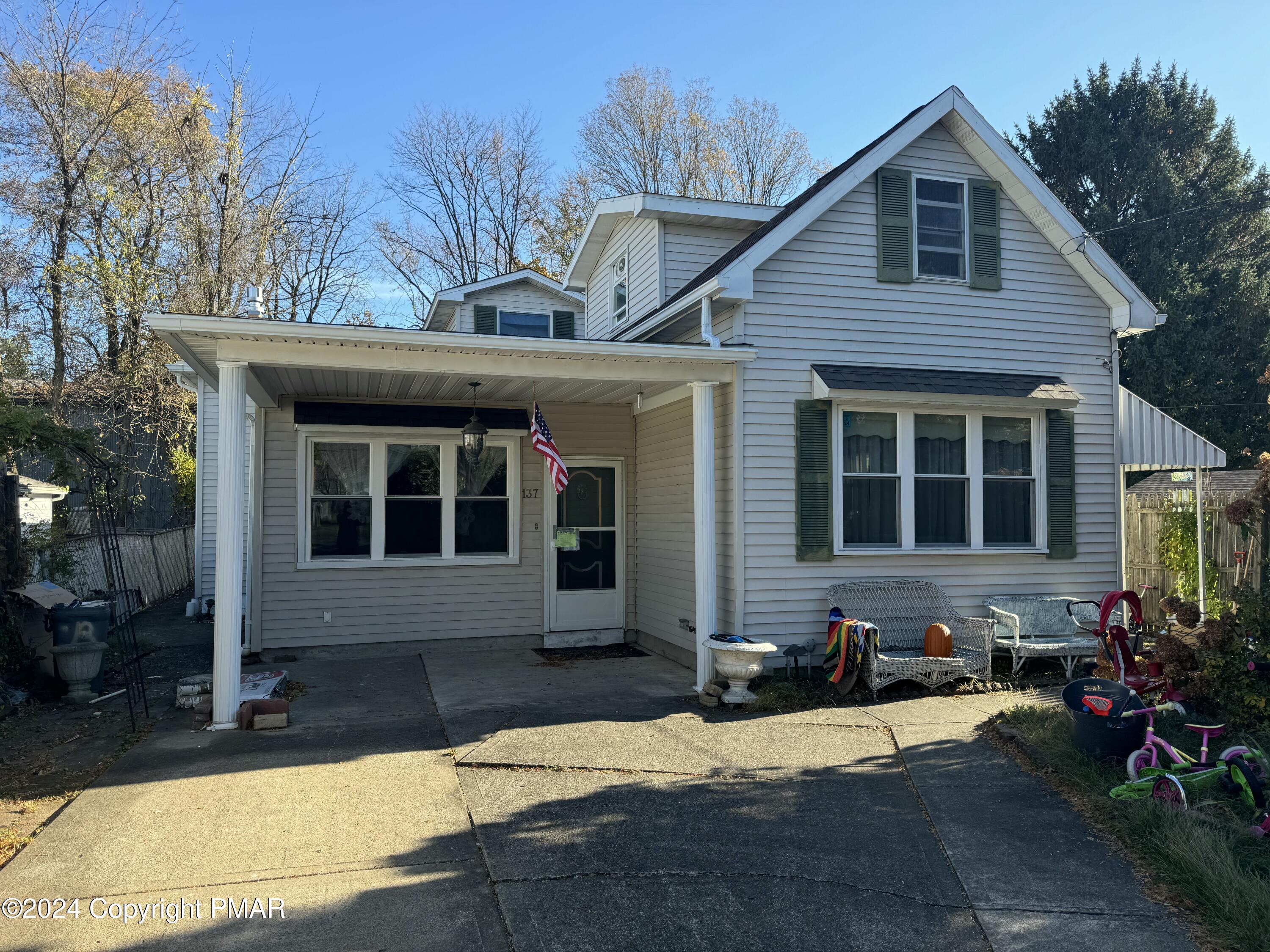 a front view of a house with yard and seating space