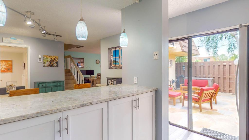 a bathroom with a granite countertop sink and a large mirror