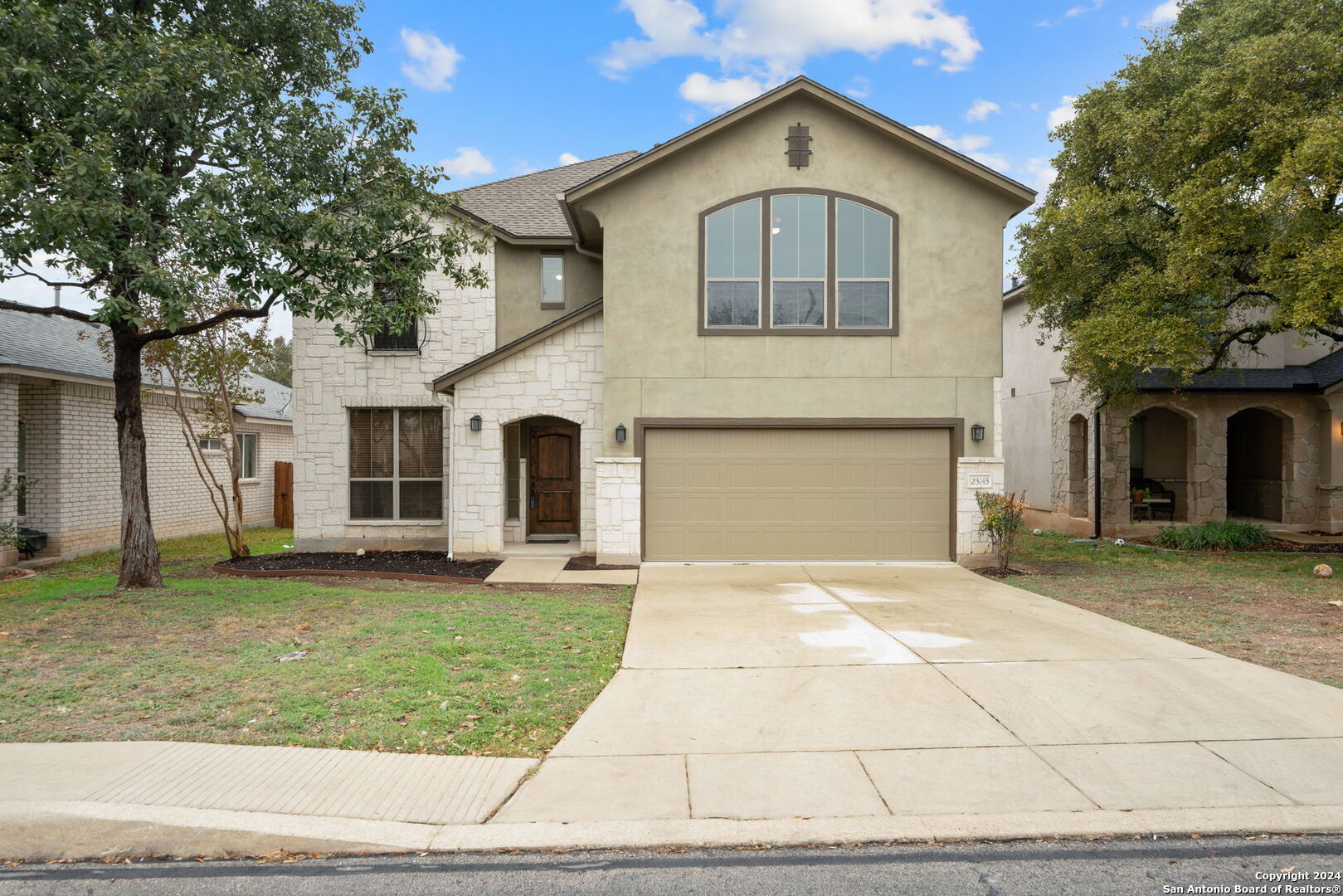 a front view of a house with a yard