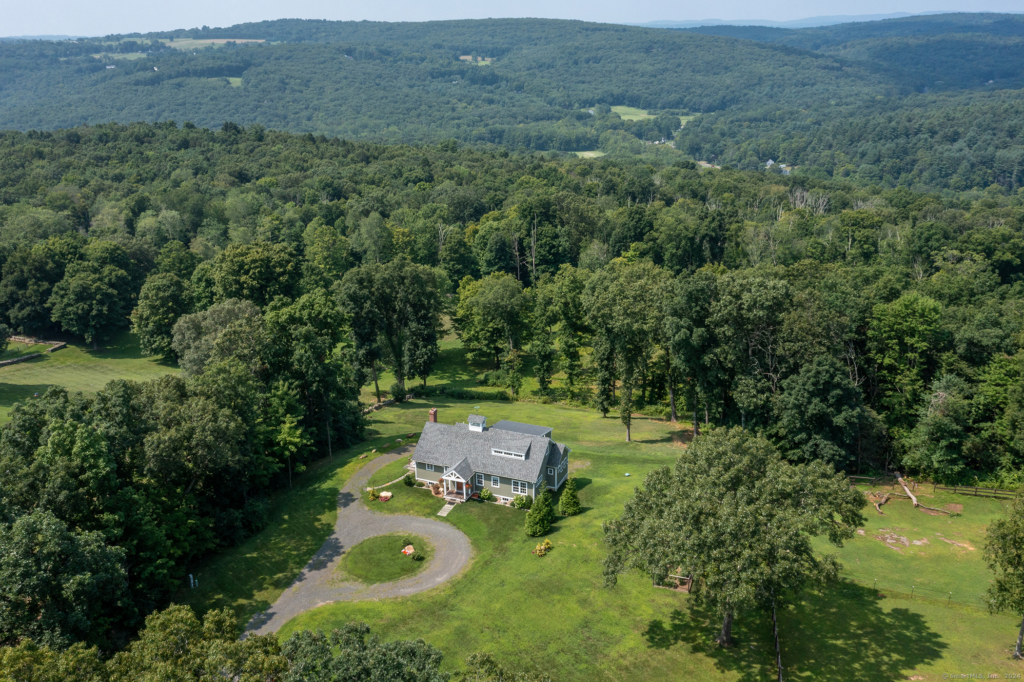 an aerial view of a forest with houses