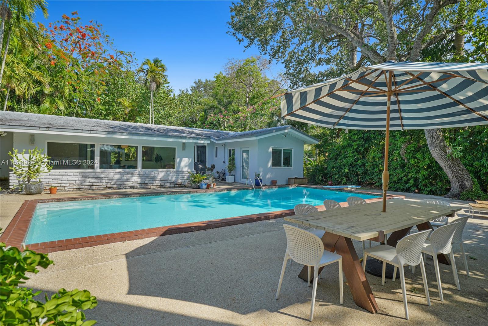 a view of a house with backyard sitting area and garden