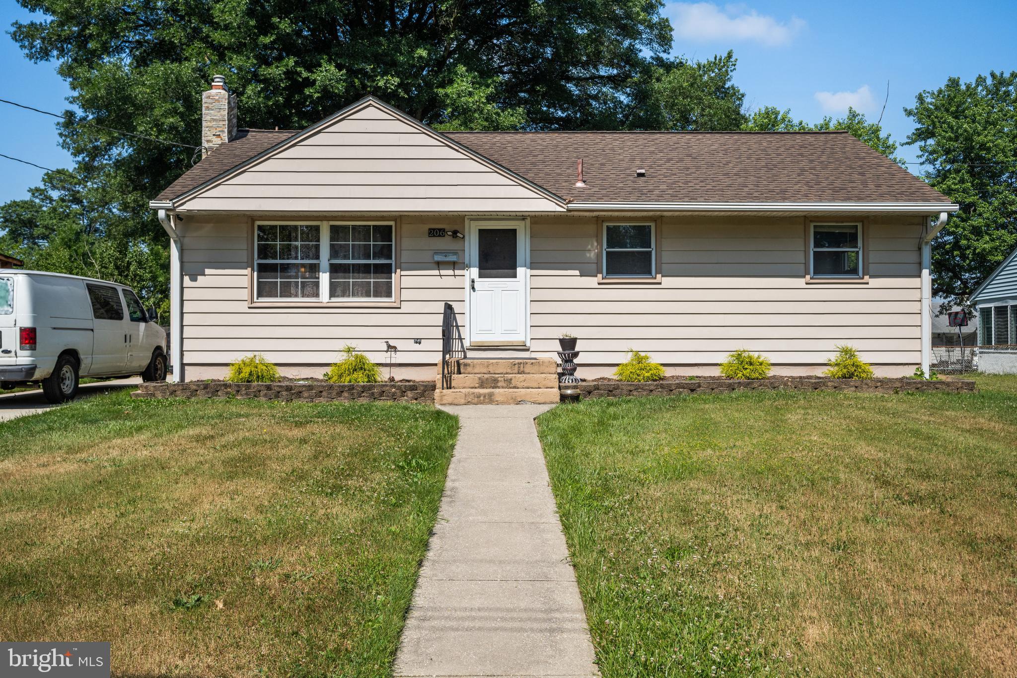 a front view of a house with a garden and patio