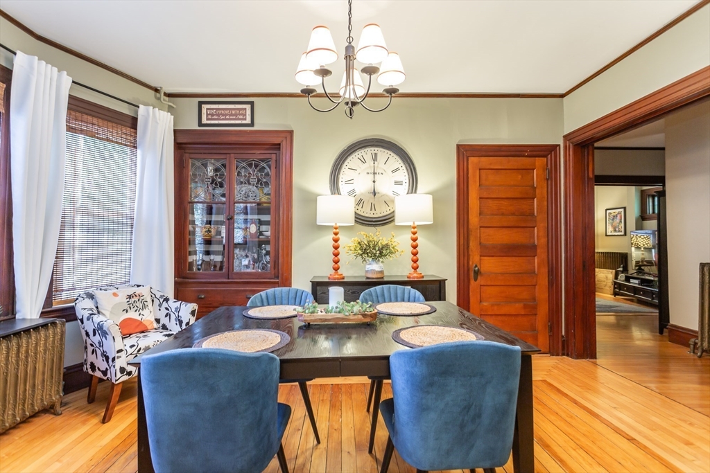 a living room with fireplace furniture and a large window