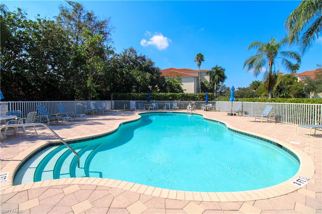 a view of a swimming pool with an outdoor seating