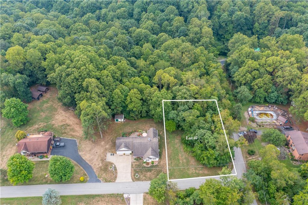 an aerial view of a house with yard