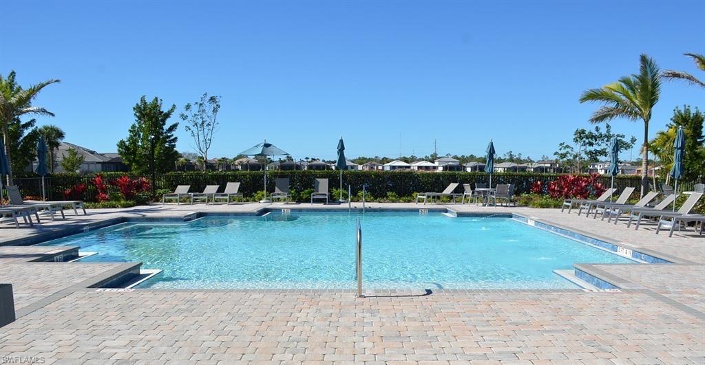 a view of a swimming pool and lounge chairs