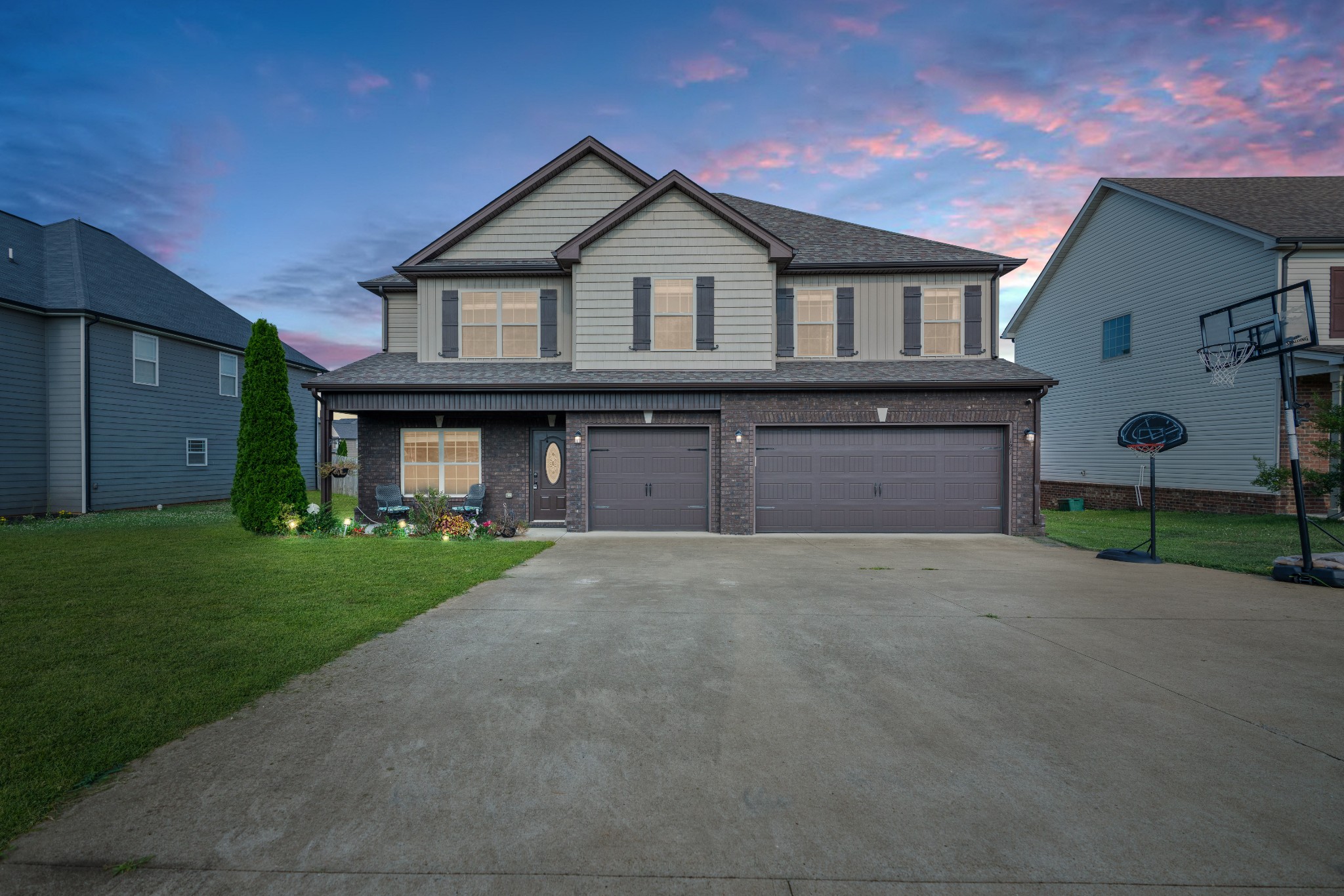 a front view of a house with a yard and garage