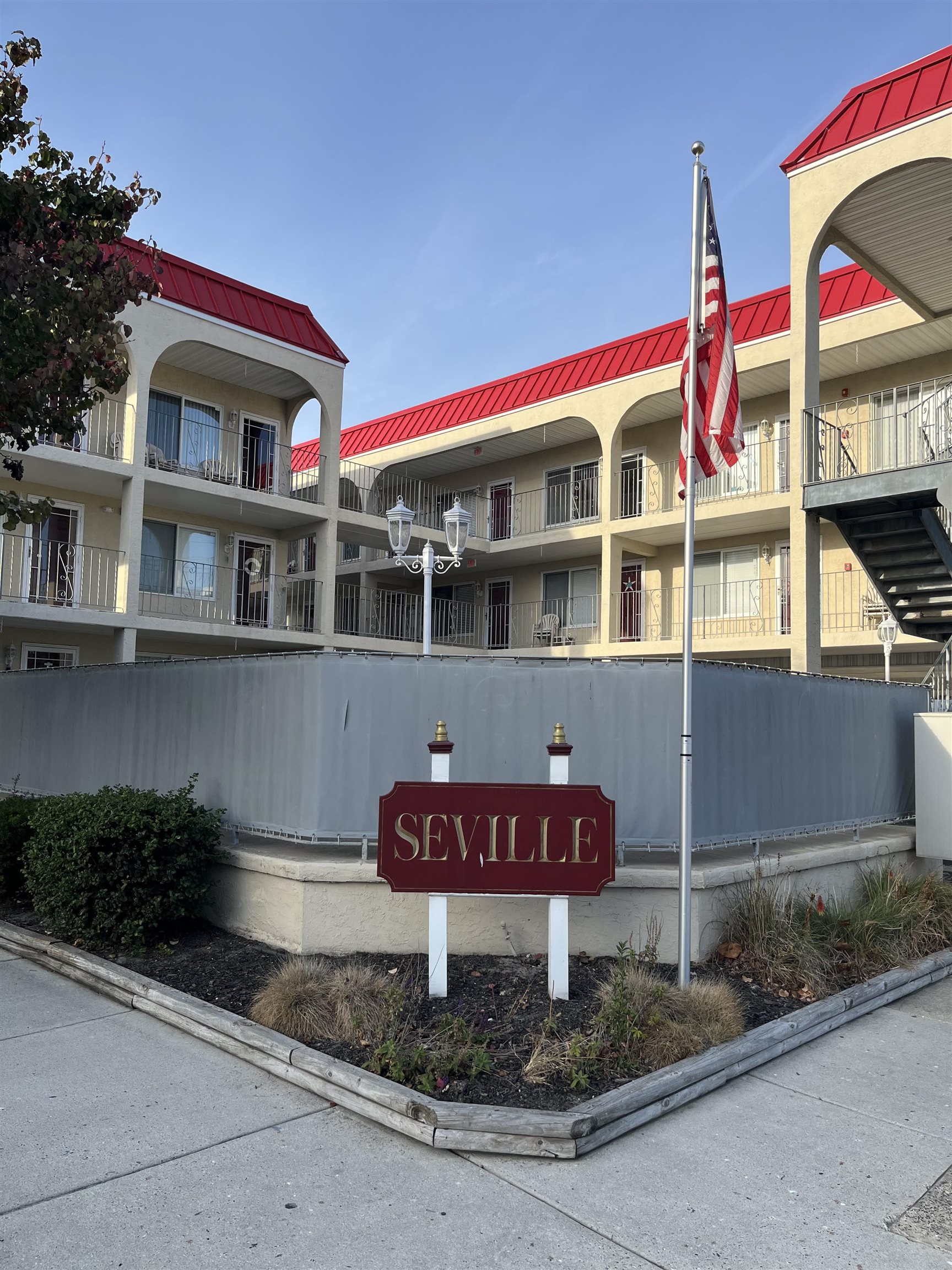 a red and white building with sign broad