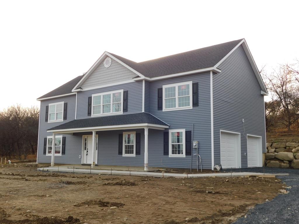 View of front of house with a porch and a garage