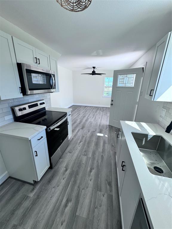 a kitchen with a sink and a stove top oven