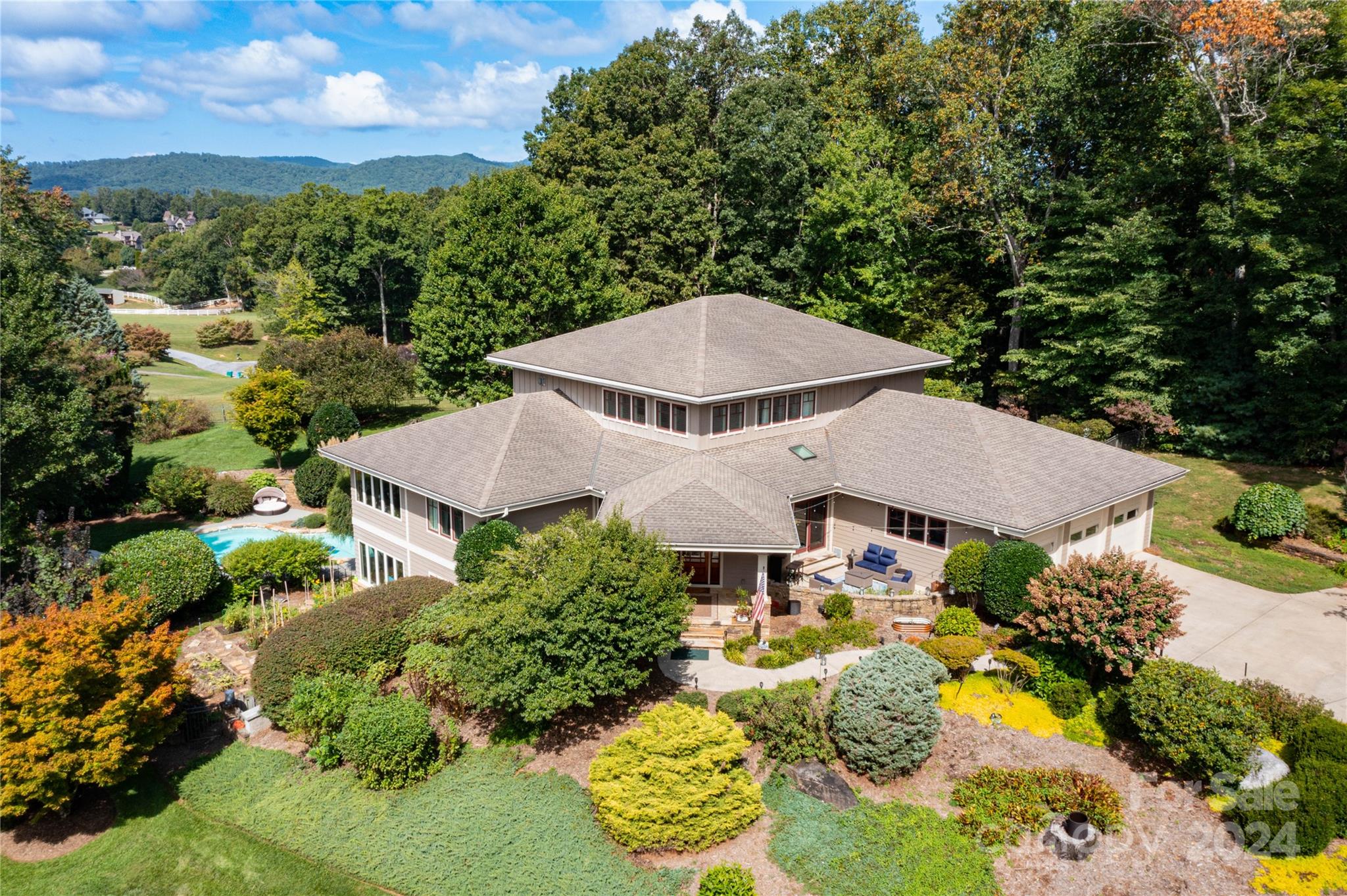 an aerial view of a house with a yard and lake view