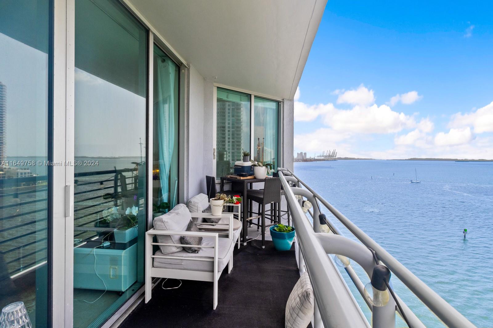 a balcony with wooden floor and furniture