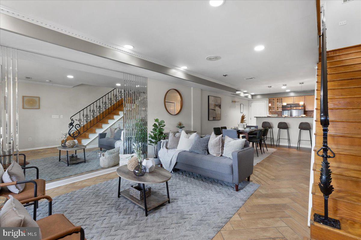 a living room with furniture and wooden floor