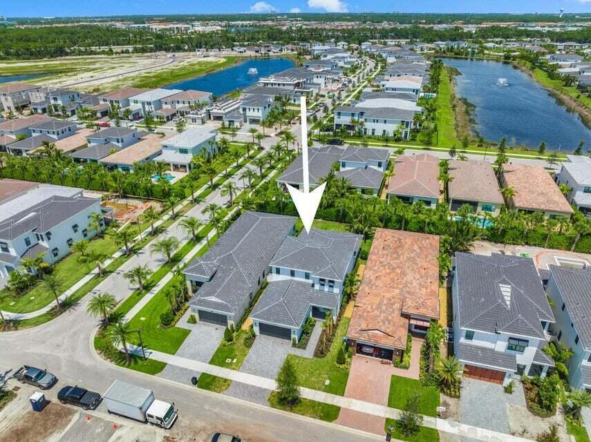 an aerial view of residential houses with outdoor space and river