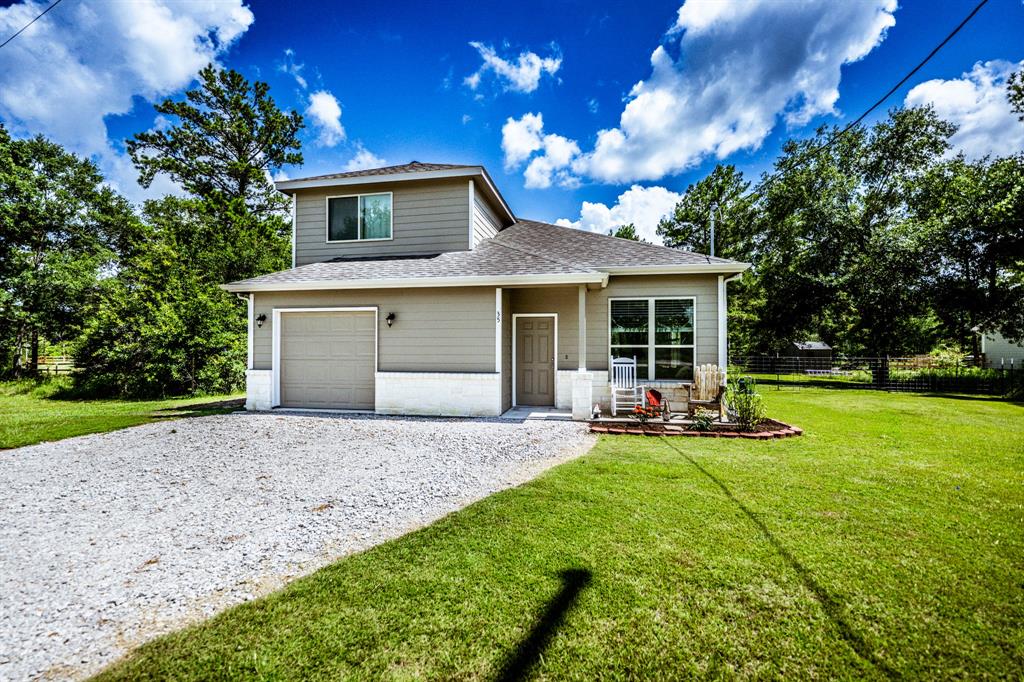 a front view of a house with patio and garden