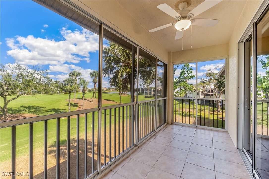 a view of a porch with a floor to ceiling window next to a yard