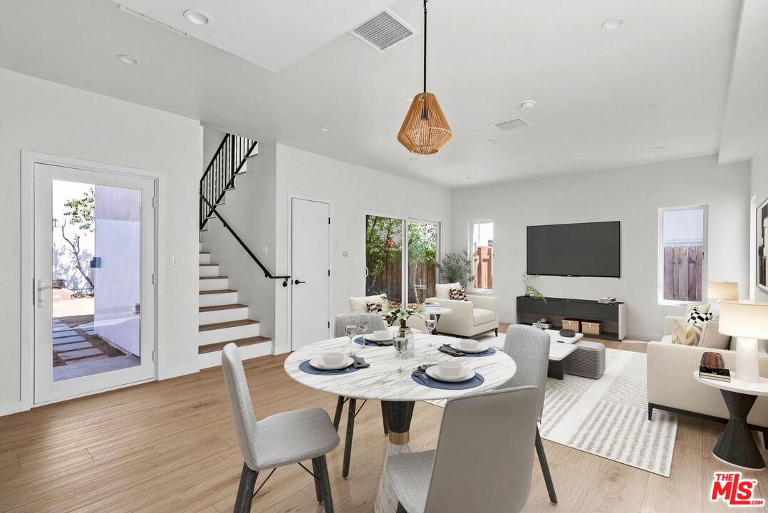 a view of a dining room with furniture wooden floor and chandelier