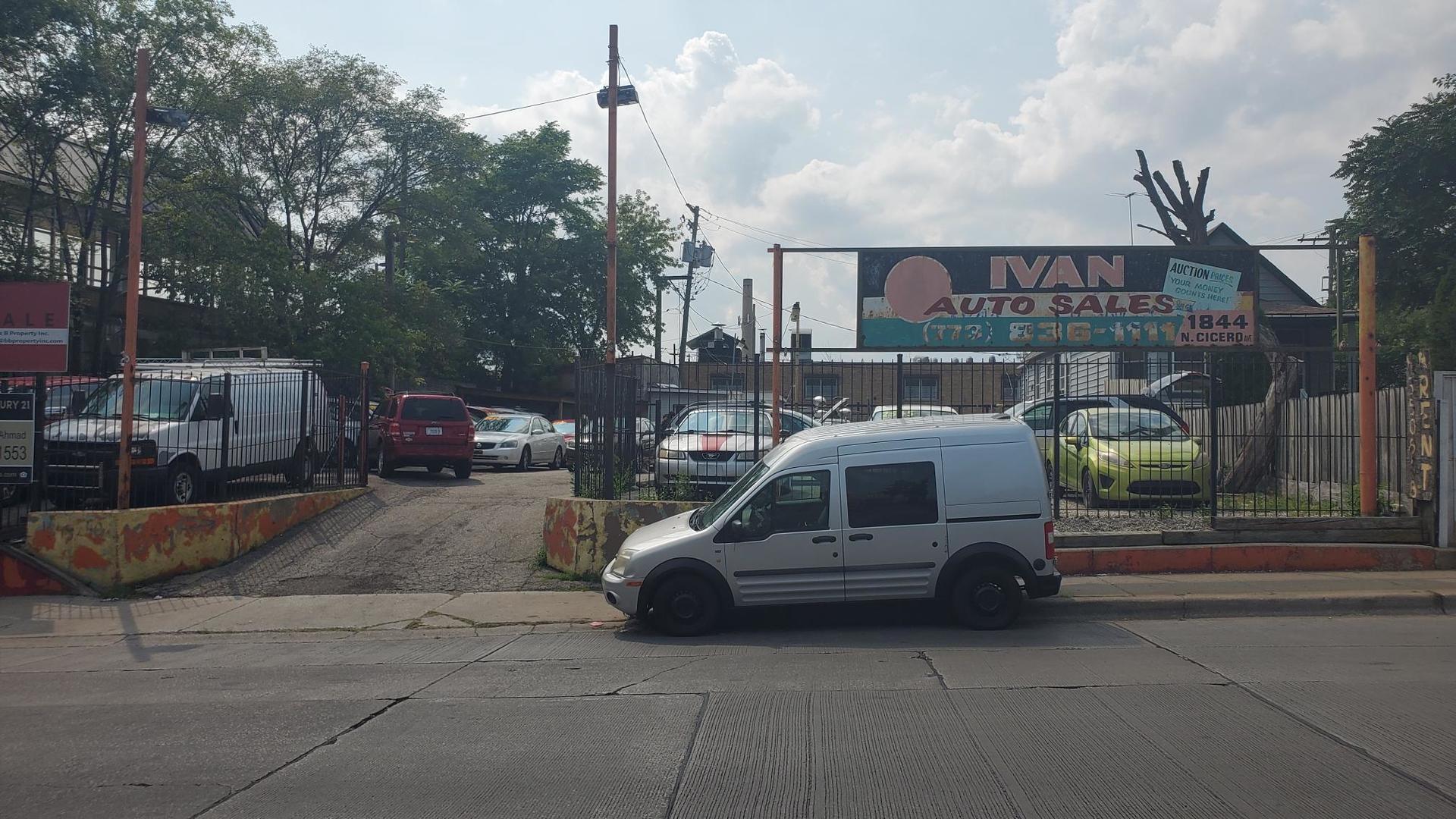 a view of a cars park in front of a building