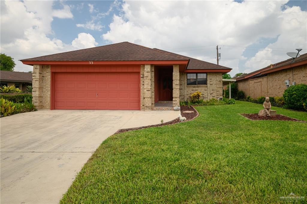 a front view of a house with a yard and garage