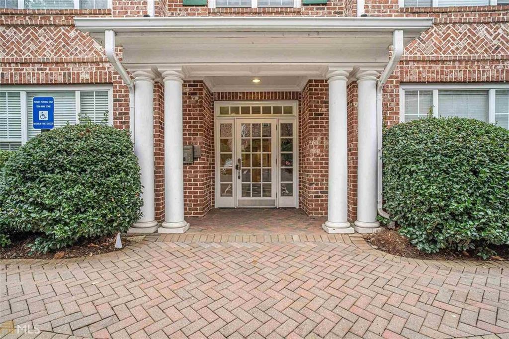 front view of a brick house with a large window