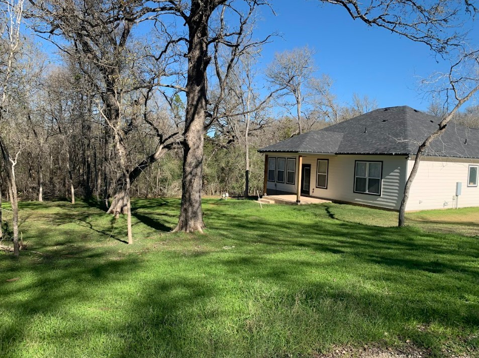 a view of a house with a yard porch and sitting area