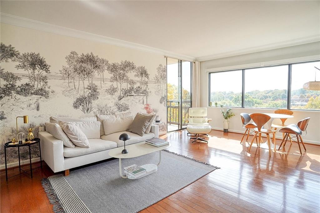 a living room with furniture and a large window with outer view