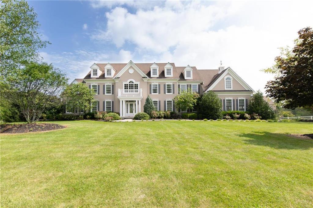 a front view of house and yard with green space