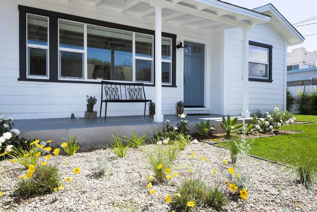 a front view of a house with a yard and flowers