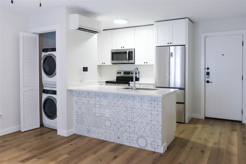 a kitchen with stainless steel appliances a refrigerator sink and stove