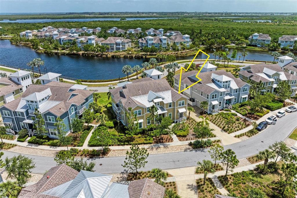 an aerial view of residential houses with outdoor space and river