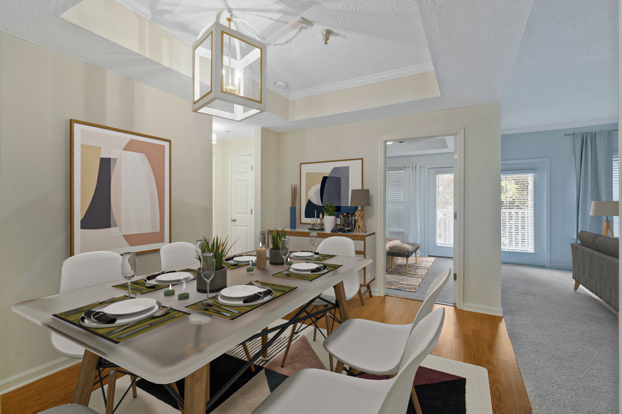 a view of a dining room with furniture a chandelier and wooden floor