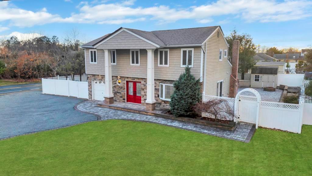 View of front of property with a front yard and a garage