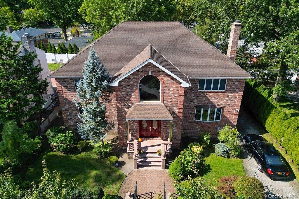 an aerial view of a house with a yard and potted plants