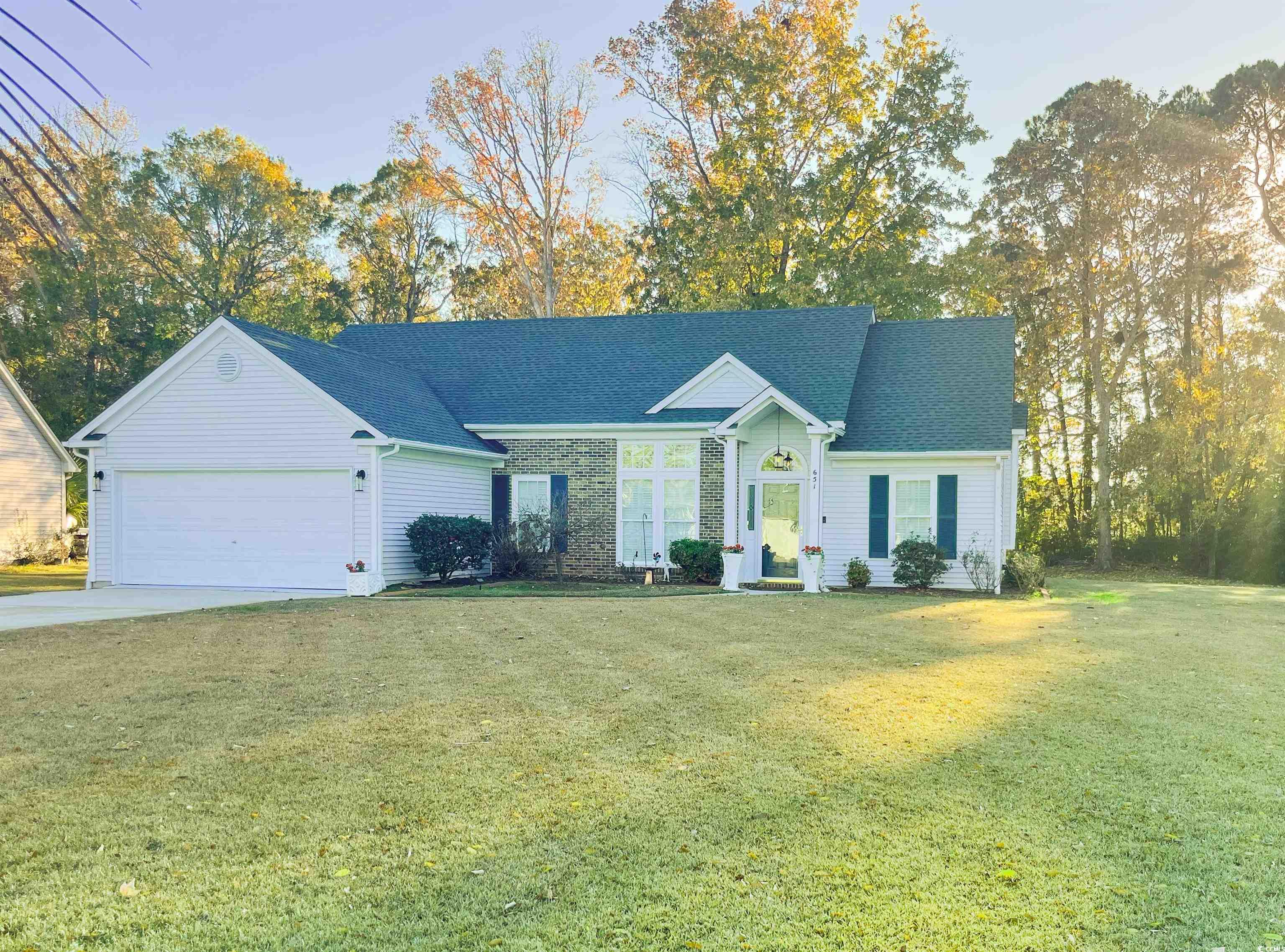 Ranch-style house featuring a garage and a front l