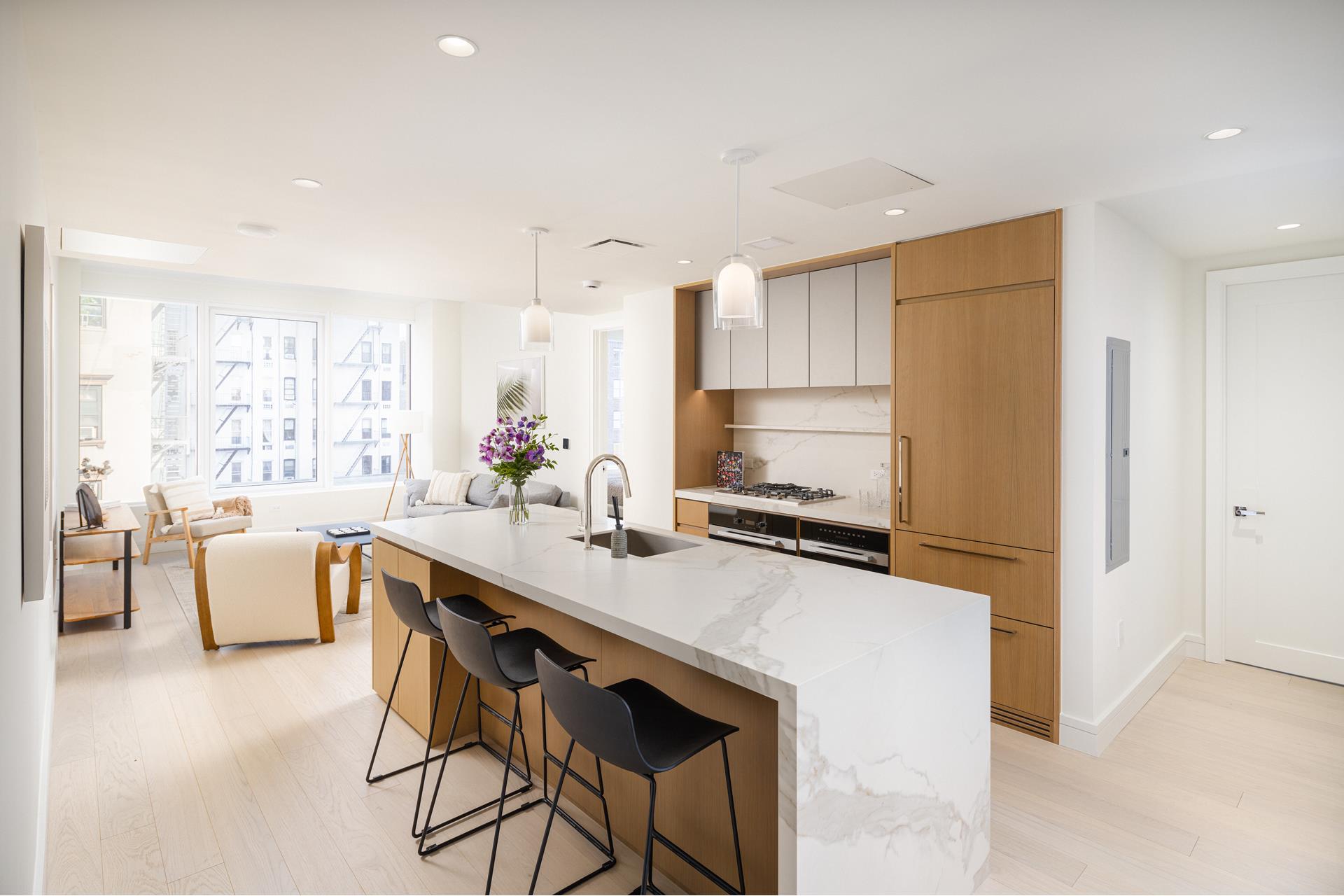 a kitchen with granite countertop a table chairs stove and refrigerator